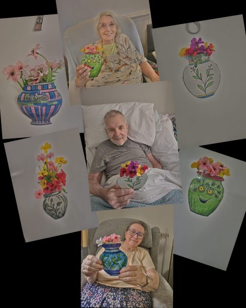 Care home residents displaying flower artwork