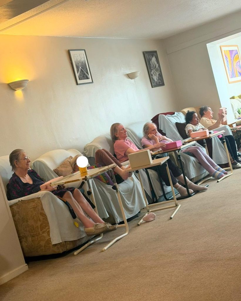 Residents enjoying a group activity in a care home lounge.