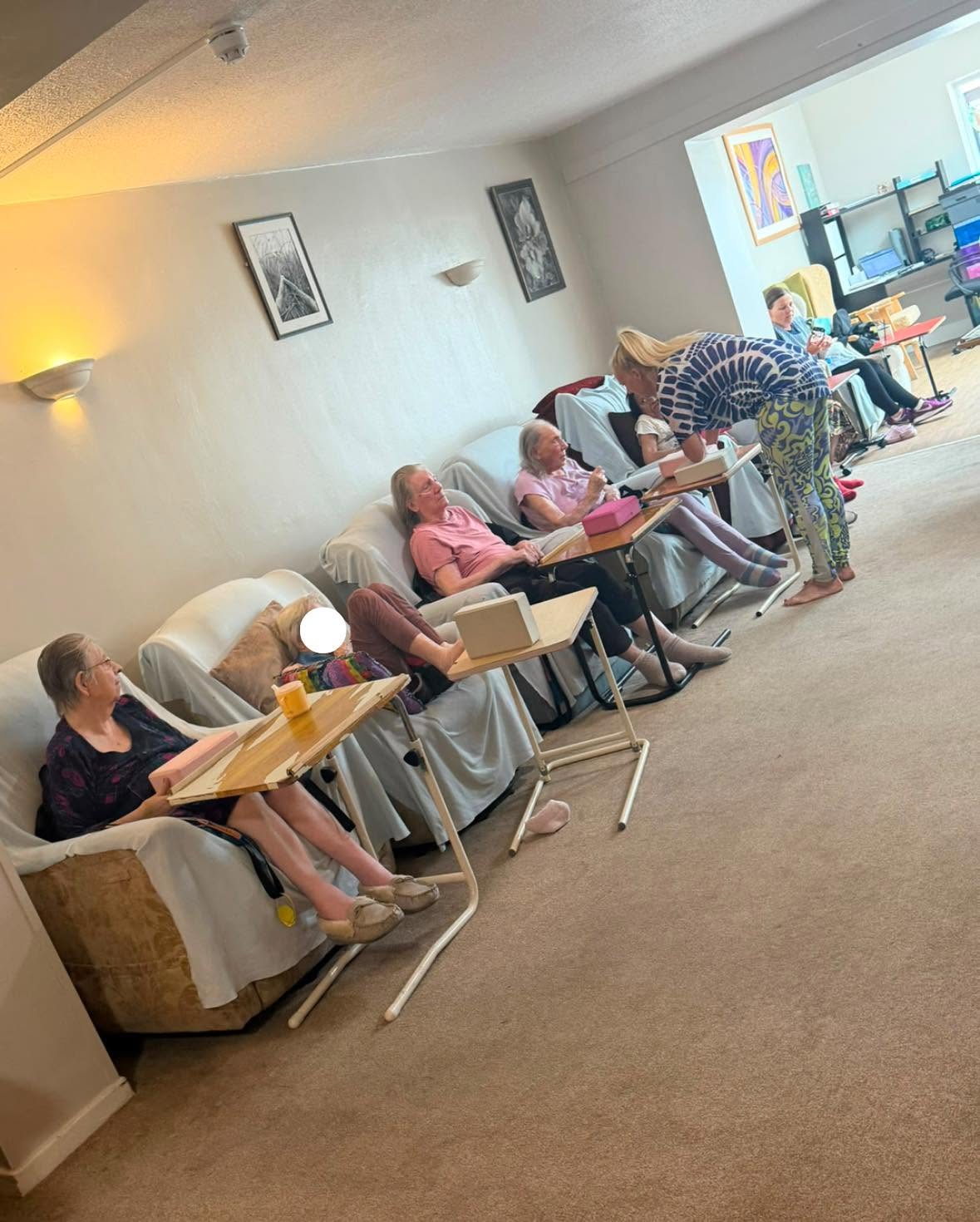 Care home residents taking part in a group activity with staff.